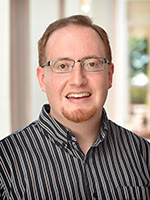 Photograph of Mitchel T. Keller, white man wearing glasses. He has a goatee.